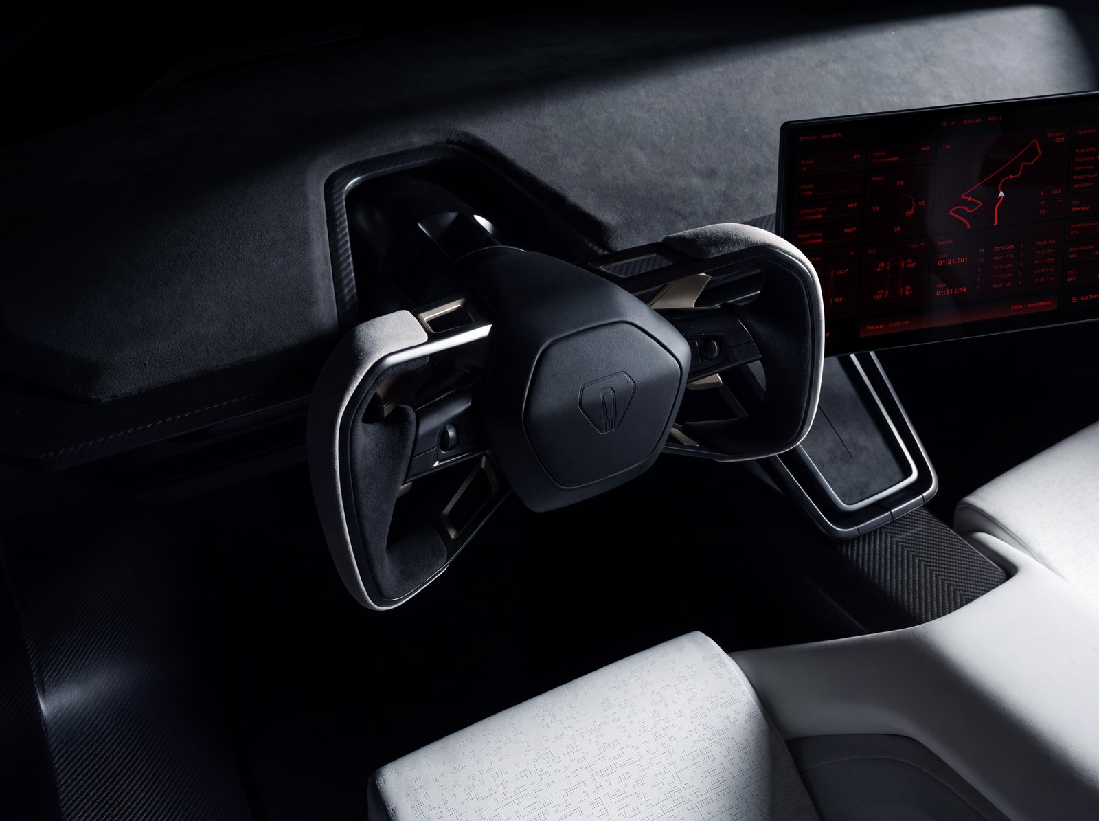Close-up of the Tesla Roadster's gray microsuede yoke, with a track map on the center touchscreen beside it