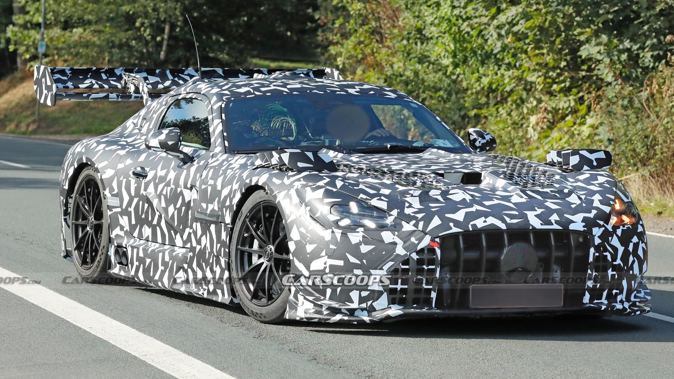 Spy shot: next AMG GT Black Series front three-quarter, camouflaged, Sep 2026